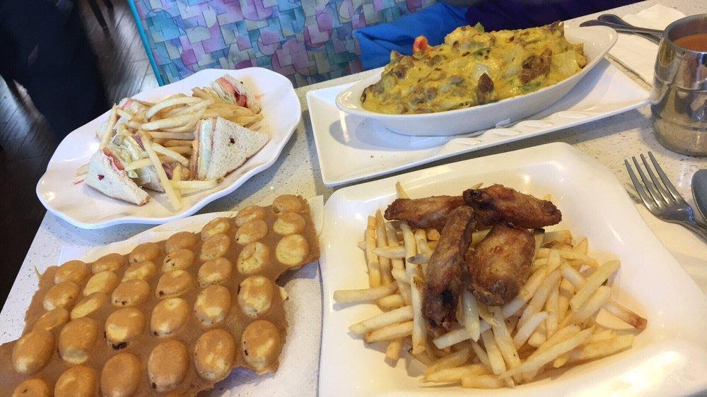 Photo of A Plus HK Style Cafe - Fremont, CA, United States. Clubhouse sandwich with fries, baked Portuguese chicken on rice, bubble waffle, and fried chicken wings with fries.